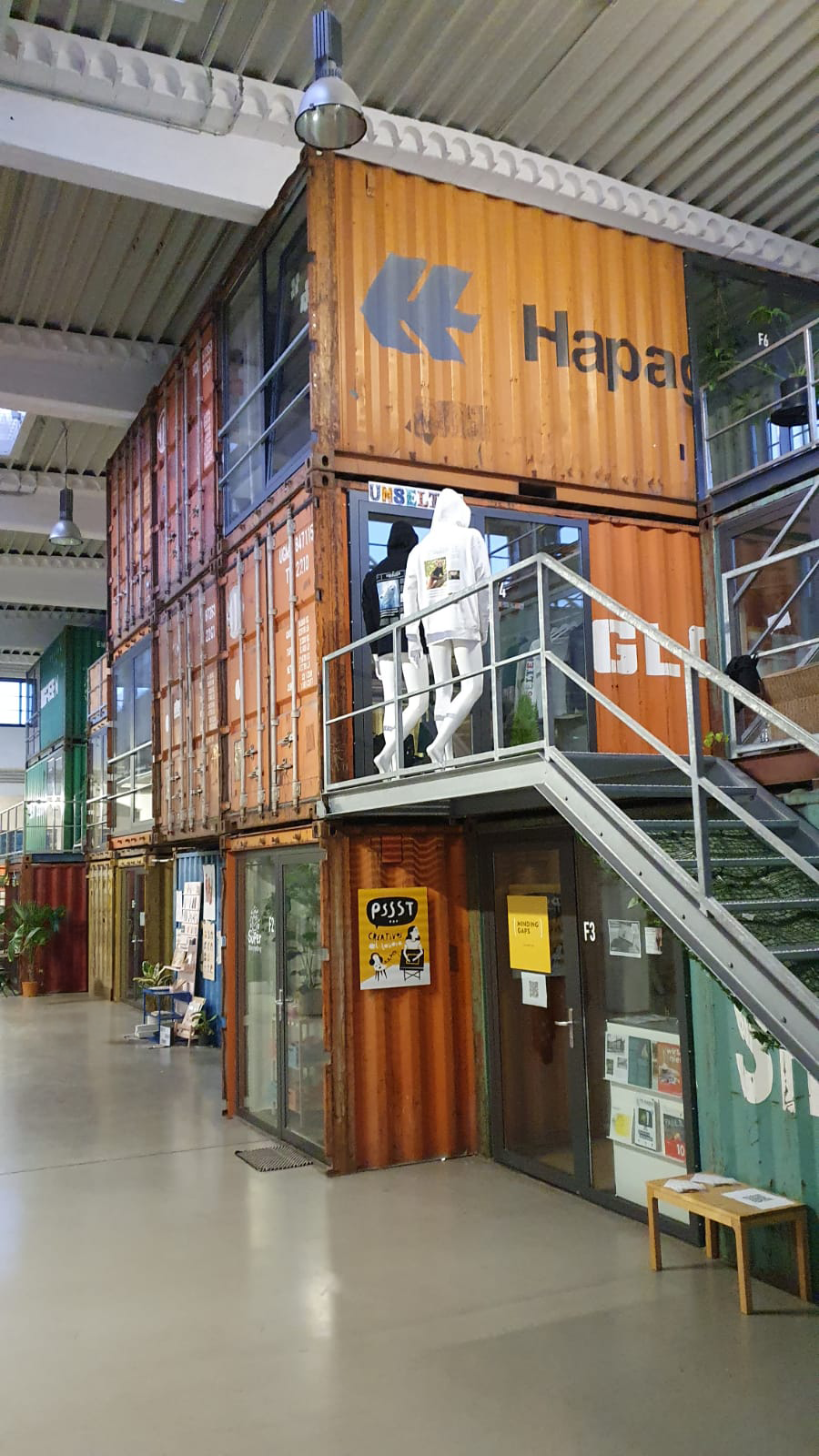 a building with a staircase and a mannequin on top of it
