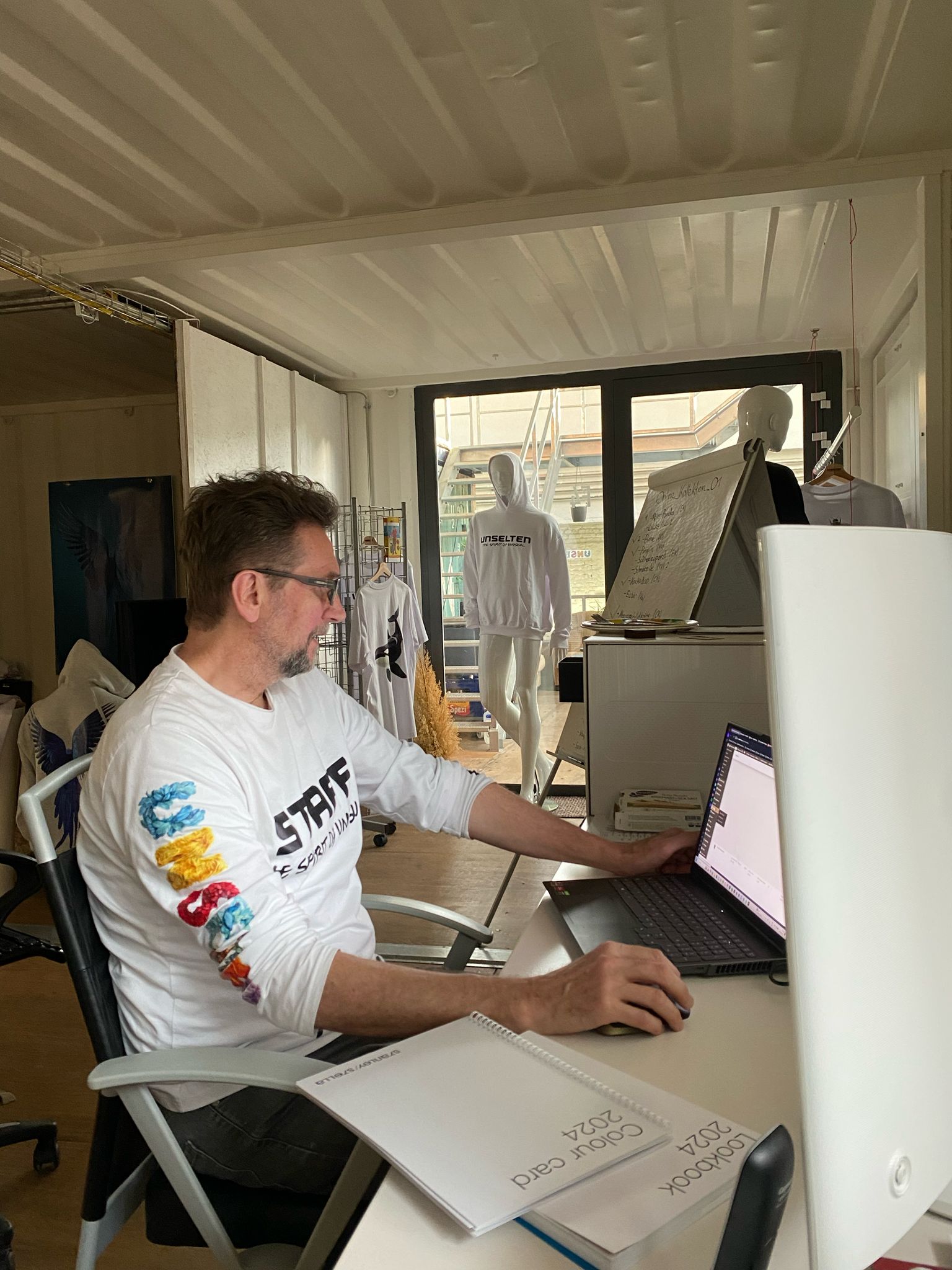 a man sitting at a desk using a laptop